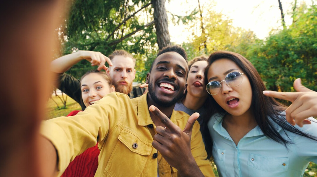 group of friends taking selfies