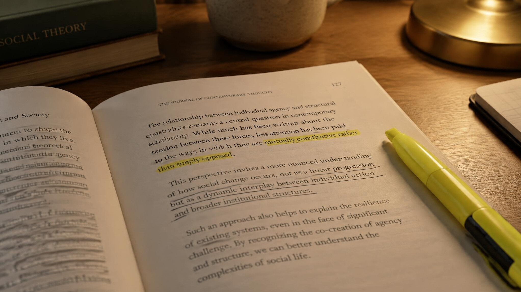 Open academic journal with underlined text and a highlighter